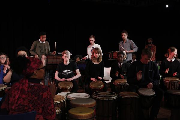 Tutor leading an African drumming group.